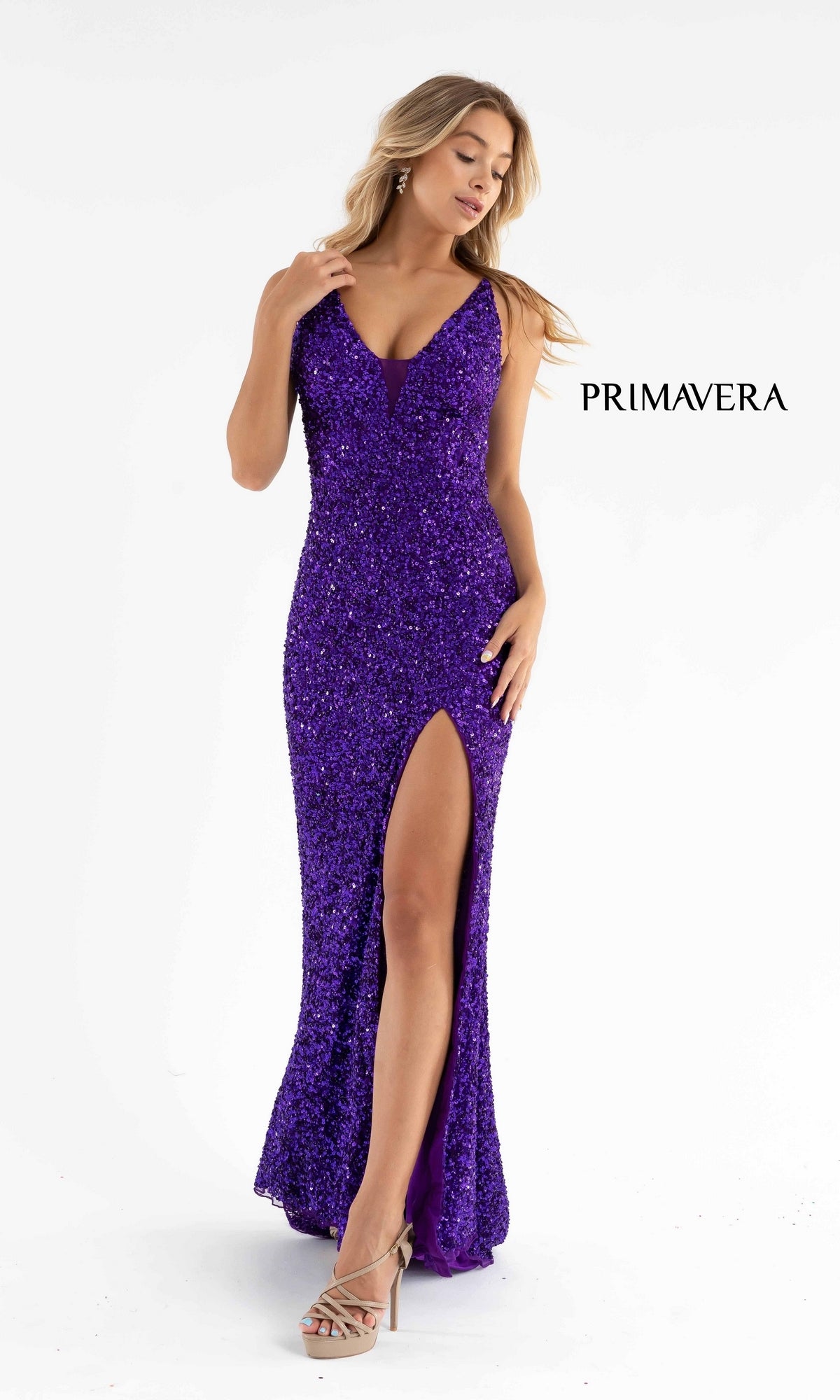 A woman models the Primavera Dark Sequin Long Prom Dress 3792D—a sleeveless deep purple gown with a V-neckline, strappy open back, fitted silhouette, thigh-high slit, and shimmering sequin embellishments—against a white background.